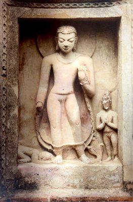 Stucco image depicting the former Buddha Dipankara in a scene from the Jataka tales. This image is part of a grouping of four images on the wall of the great Monument of Site 3.